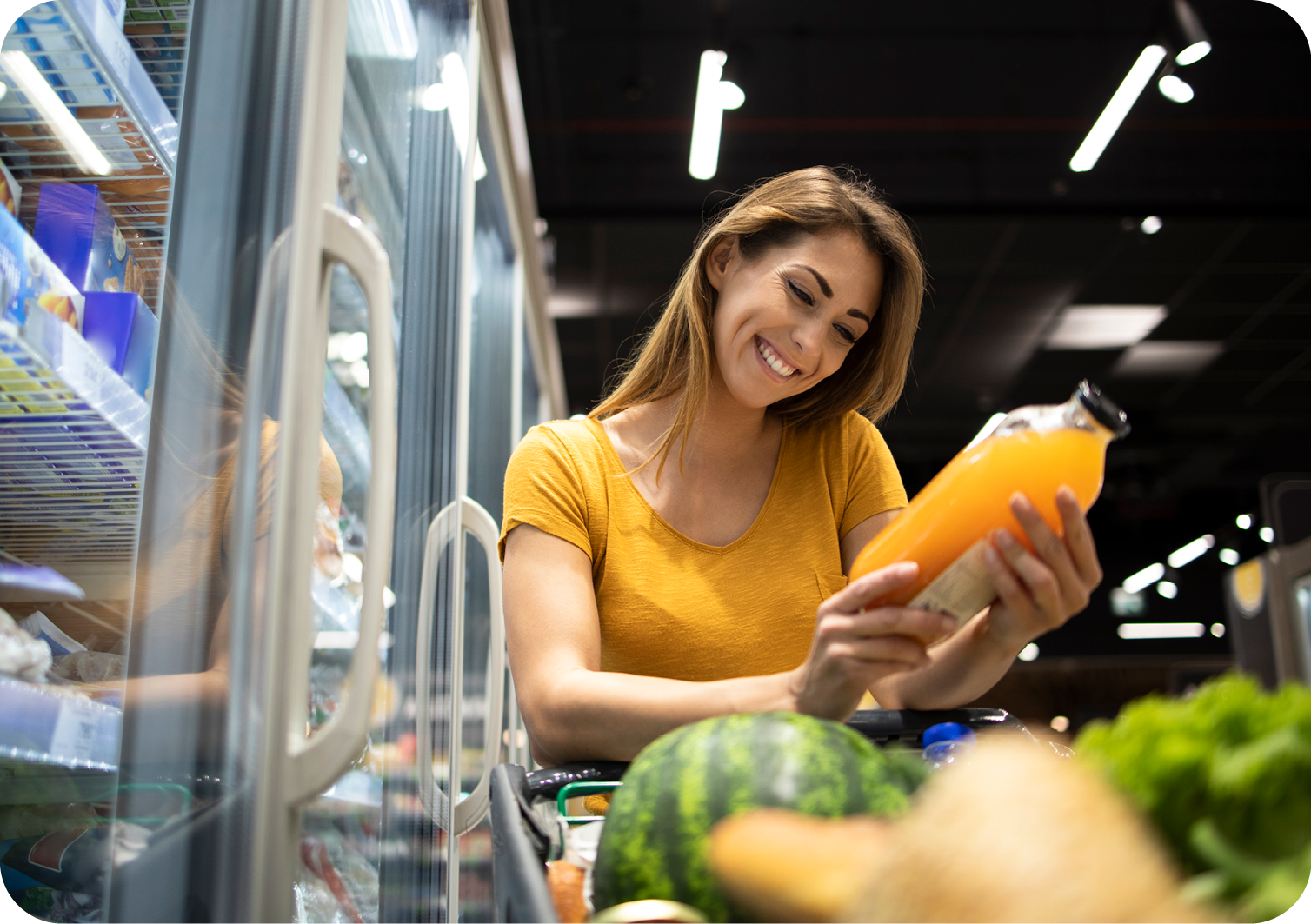 Woman looking at orange juice